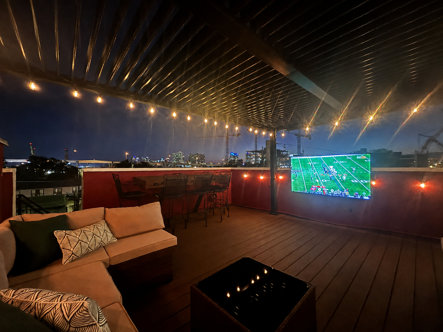 Urban Perch rooftop at night with string lights and Tampa skyline