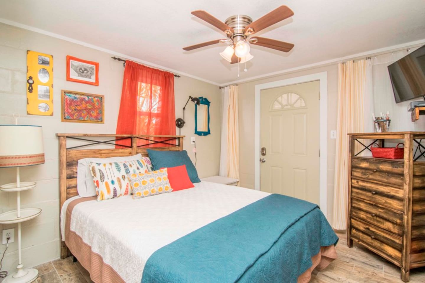 Queen bedroom with barn door and original art