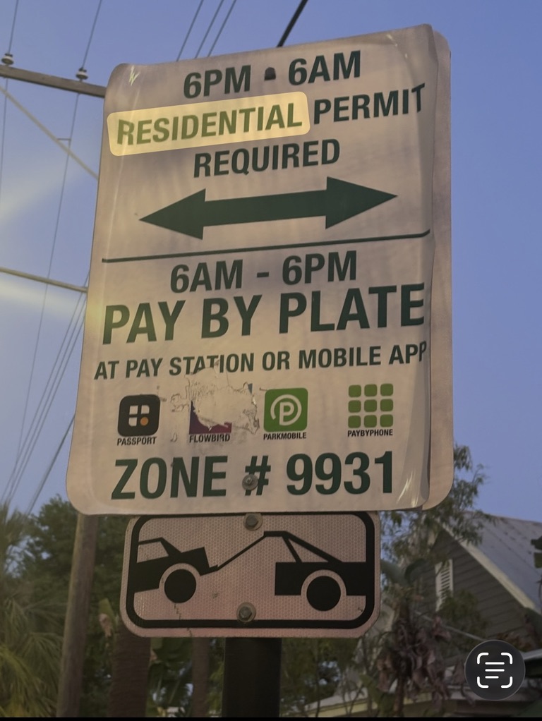 Ybor City sign showing residential permit parking from 6 p.m. to 6 a.m. and pay-by-plate parking from 6 a.m. to 6 p.m.